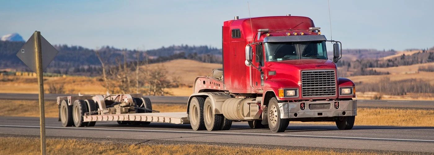 Specialized flatdeck trailer transporting oversized industrial equipment